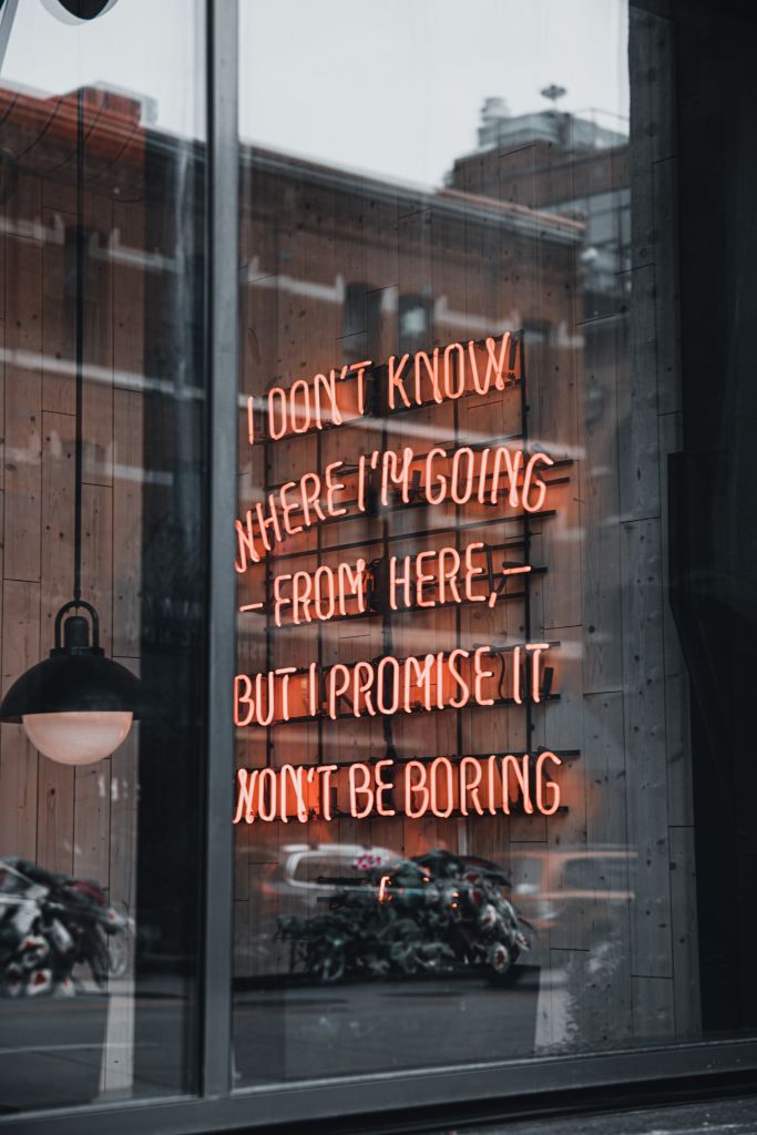 Sign that reads, "I don't know where I'm going from here but I promise it won't be boring", self care is looking for the things that excite you and giving yourself permission to do them.
